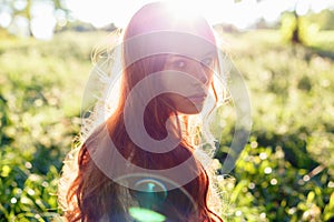 Portrait of a girl with red hair in the Sun