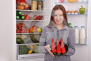 Portrait of a girl with a red hot pepper.