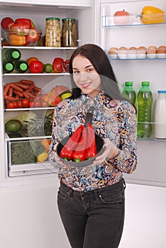 Portrait of a girl with a red hot pepper.