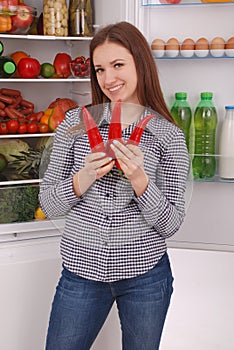 Portrait of a girl with a red hot pepper.