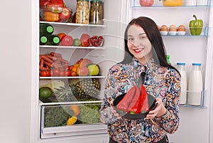 Portrait of a girl with a red hot pepper.