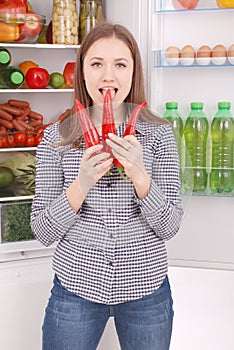 Portrait of a girl with a red hot pepper.