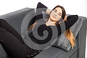 Portrait of a girl relaxing and smile on a sofa on white background