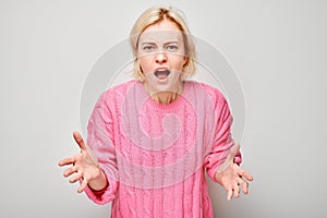 Portrait of girl screaming with anger, freaking out, breakdown on white background. Depression, uncertainty, nervous