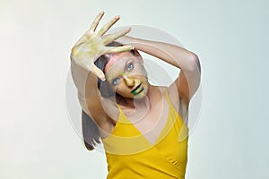 Portrait of a girl with smeared makeup. hand shows the stop sign