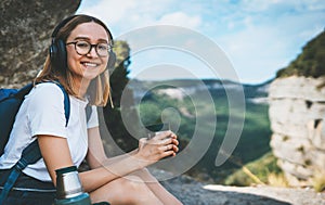 Portrait girl smile travel in mountain drinking coffee from thermos enjoying summer trip, fun female hipster tourist with glasses
