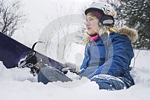 Portrait of a girl snowboarder in the snow