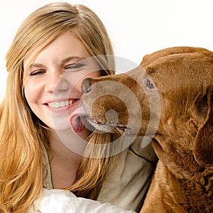 Portrait of girl snuggling with her dog