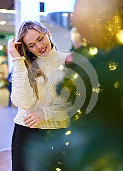 portrait of a girl in a sweater in a mall