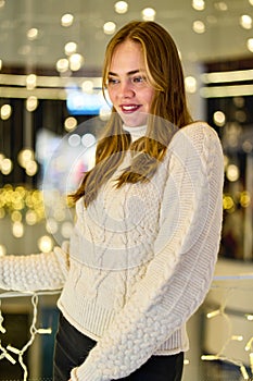 portrait of a girl in a sweater in a mall