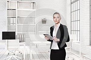 Portrait of girl with tablet in suit in office