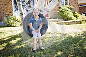 Portrait of girl on tire swing