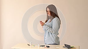 Portrait of a girl with type 1 diabetes makes a injection of insulin at home.