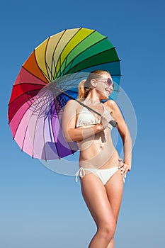 Portrait of girl under rainbow parasol