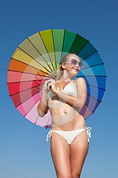 Portrait of girl under rainbow parasol