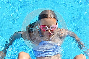 Portrait of a girl underwater. The child in the water during the summer. Interesting photo