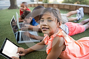 Portrait of girl using digital tablet at park