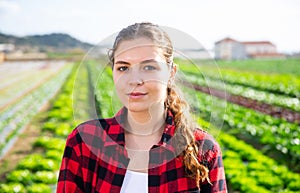 Portrait of girl vegetable grower in family vegetable farm