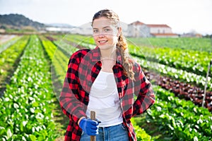 Portrait of girl vegetable grower in family vegetable farm