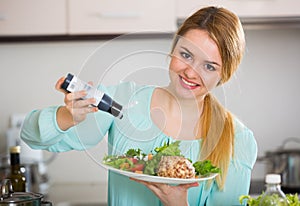 Portrait of girl with vegetable salad and balsamico