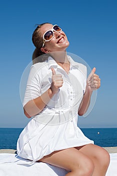 Portrait of girl in white short dress and tinted sunglasses