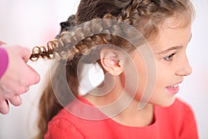 Portrait of a girl whose long braided pigtail, photo