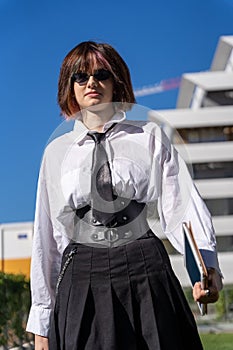 Portrait of a girl in work clothes with a leather corset around her waist