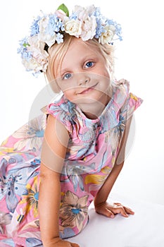 Portrait of girl with a wreath of flowers.