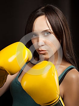 Portrait of a girl in yellow boxing gloves