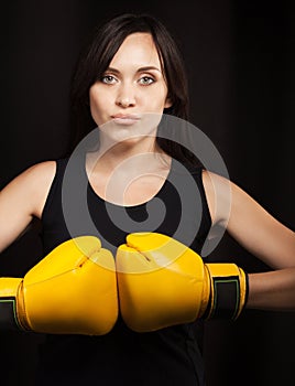 Portrait of a girl in yellow boxing gloves