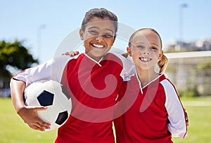 Portrait of girls on field, sports and soccer player, smiling with teammate. Soccer ball, football and young kids having