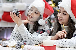 Portrait of girls in Santa hat preparing for Christmas