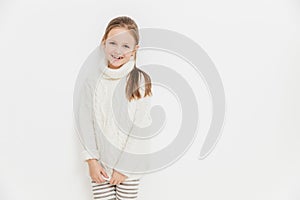 Portrait of glad satisfied girl wears warm white knitted sweater