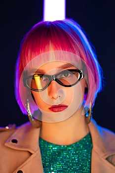 Portrait of glamorous woman on party under glowing neon light. Nightclub, trendy outfit. Teenager, zoomer Z-generation