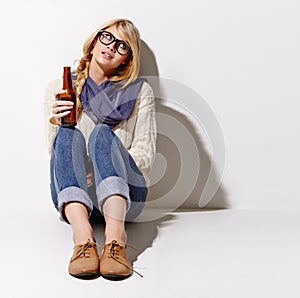 Portrait, glass beer bottle and thinking with a woman in studio on a mockup white background. Party, event or space with