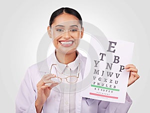Portrait, glasses and eye test with a woman optician in studio on a gray background for vision or eyesight. Face, smile