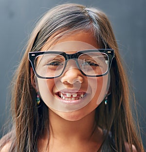 Portrait, glasses and girl in studio with eye care for optometry, prescription and confidence. Smile, kid and frame of