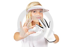 Portrait, golf ball and white background of woman in studio with glove hands, sports uniform and face. Young female