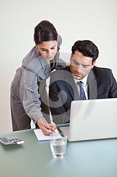 Portrait of a good looking business team working with a laptop