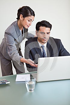 Portrait of a good looking business team working with a notebook