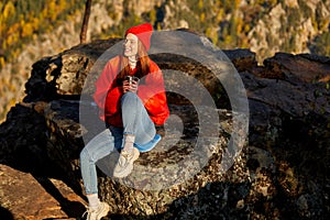 Portrait of good-looking fit redhead woman is travelling on mountains