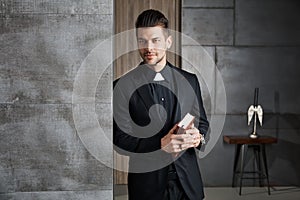 Portrait of good-looking young catholic priest