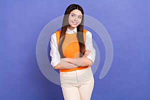 Portrait of good mood girl wear stylish shirt orange vest look at offer empty space arms crossed isolated on violet