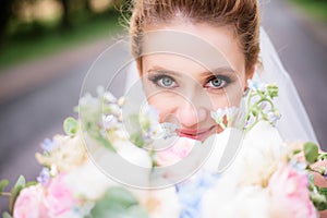 Portrait of a gorgeous bride with tender skin and deep blue eyes