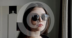 Portrait of a Gorgeous Dark Haired Hispanic Woman with sunglasses at modern home