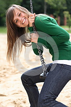 A portrait of the gorgeous girl on a swing