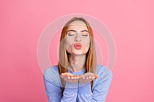 Portrait of gorgeous lovely girl with foxy hairdo wear blue pullover send you air kiss close eyes isolated on pink color