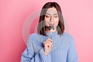 Portrait of gorgeous positive lady closed eyes arm hold lick spoon isolated on pink color background