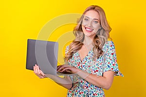 Portrait of gorgeous pretty positive lady wear stylish clothes hold netbook use modern device isolated on yellow color