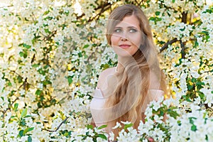 Portrait gorgeous woman in blooming garden